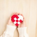 Giving Tuesday concept with woman hands holding red and white heart, charity day concept