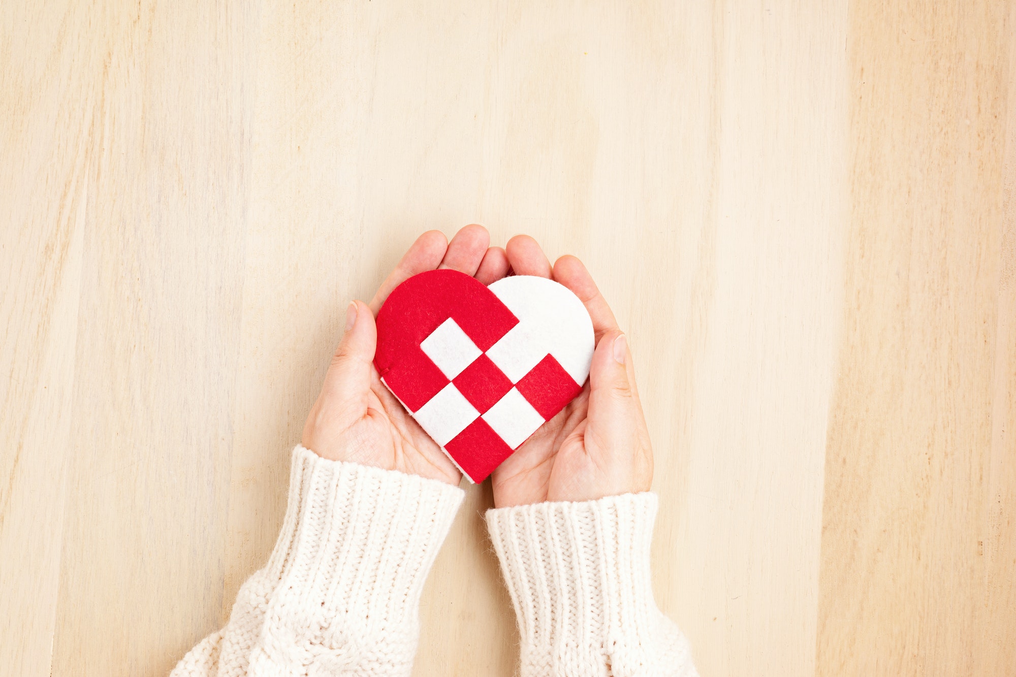 Giving Tuesday concept with woman hands holding red and white heart, charity day concept